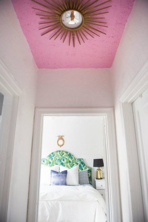 A bold pop of color on the ceiling makes a drastic difference in this hallway design.