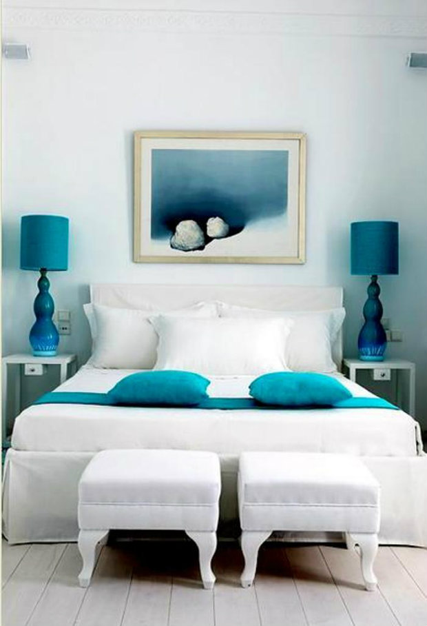 This crisp white room is given life with pops of blue teal color within the accents.